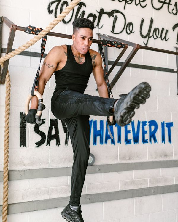 Man performing a controlled strength exercise in a focused environment.